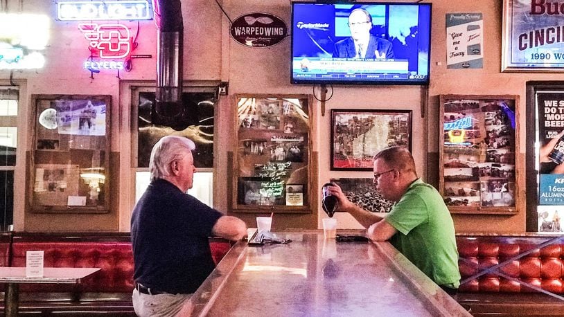 Marlin Younce, left and Andy Good, both from Dayton, enjoy each other's company and the baseball game at Kramer's Tavern on Irving Ave. near the University of Dayton. The COVID-19 pandemic has cut into business and cancellation of most college sports will amplify the impact. JIM NOELKER/STAFF