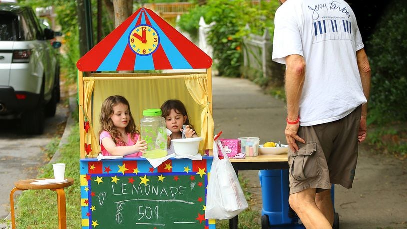 In this 2014 file photo, Jerry Farber stops to buy a cup of lemonade from Cayla Drake (left), 7, and her sister Jamie Drake (right), 5.   CURTIS COMPTON / CCOMPTON@AJC.COM