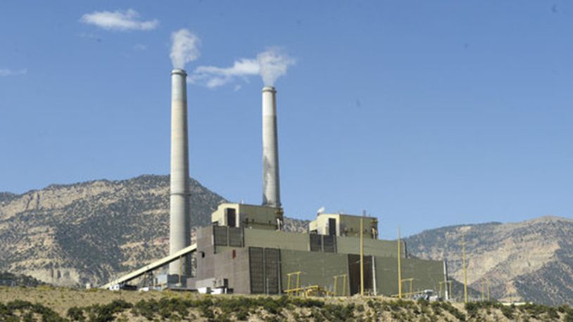 In this Sept. 8, 2015 photo, a natural gas rig pumps away in the foreground of the coal-fired Huntington Power Plant west of Huntington, Utah. A 20-year plan by Utah's largest electricity provider stipulating that it will not add pollution-control systems to its coal power plants has received criticism from some in the state who say the proposal may violate a U.S. Environmental Protection Agency requirement and get in the way of the federal push to curb regional haze, The Salt Lake Tribune reports. (Al Hartmann/The Salt Lake Tribune via AP)