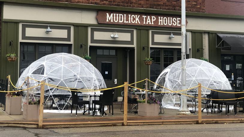 Mudlick Tap House in downtown Dayton installed plastic igloos on its patio to keep guests safe during the coronavirus pandemic. CORNELIUS FROLIK / STAFF FILE