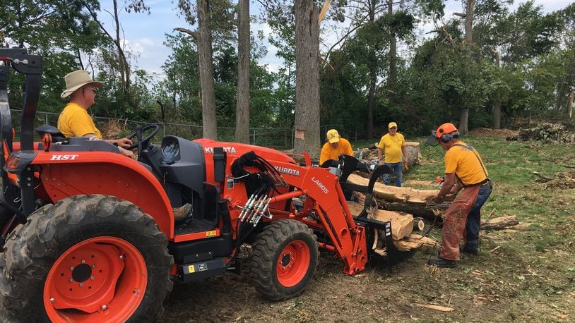 Members of the national organization Southern Baptist Disaster Relief help remove trees and debris from a backyard on Rushton Drive Wednesday June 5, 2019. RICHARD WILSON/STAFF