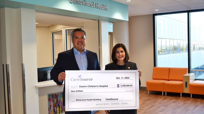 CareSource president and CEO, Erhardt Preitauer, presents a $2 million donation to Debbie Feldman, president and CEO of Dayton Children’s Hospital. The donation will go toward Dayton Children's new behavioral health building, which they plan to break ground on in 2023 and open in 2025. CONTRIBUTED