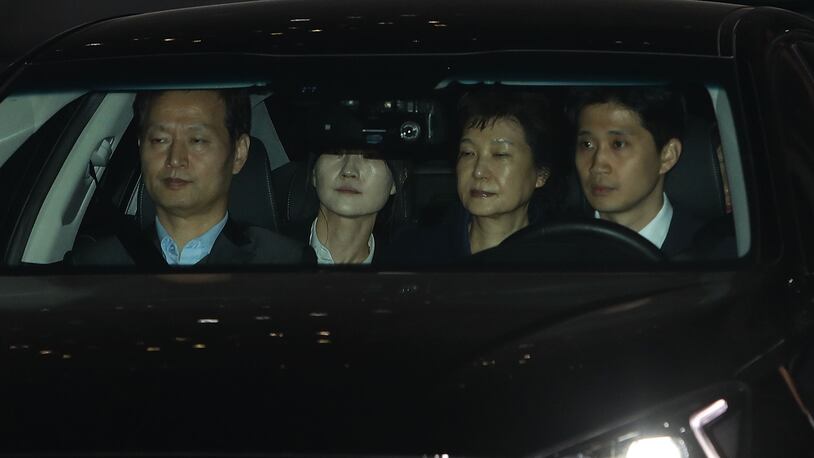 Ousted South Korean President Park Geun-hye (second from right), leaves the prosecutors' office as she is transferred to a detention house on Friday. The Seoul Central District Court approved a warrant to arrest ousted South Korean President Park Geun-hye.  (Photo by Chung Sung-Jun/Getty Images)