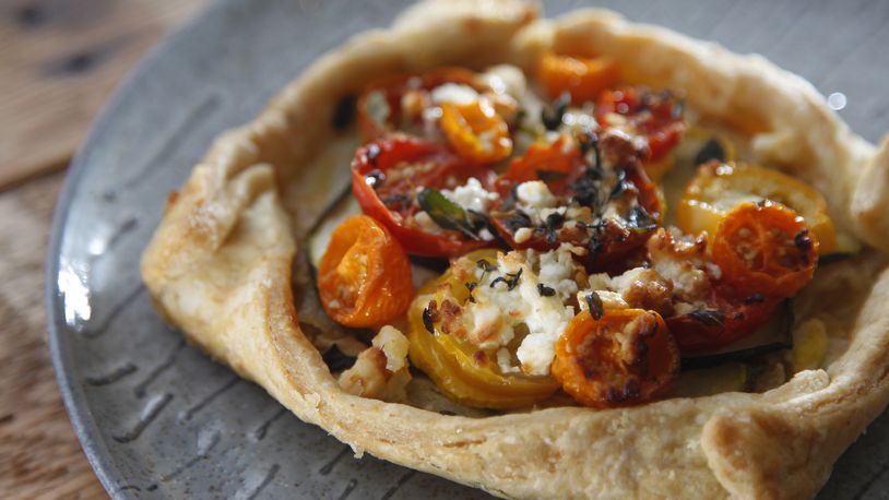 A zucchini, tomato and feta tart from St. Anne the Tart, a new bakery and coffee house in Dayton's St. Anne's Hill historic neighborhood. LISA POWELL / STAFF