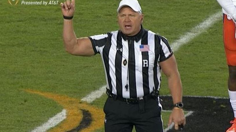 This ref brought some 'guns' to the Clemson-Alabama game. PHOTO / ESPN College Football Twitter @ESPNCFB