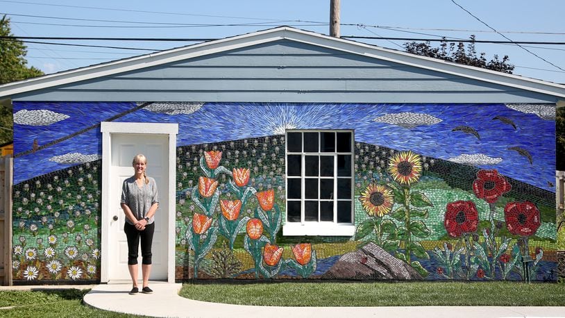 Guustie Alvarado, a Tipp City artist, spent a year creating “Covid Wall,” a glass mosaic on her garage. The artwork is filled with images meaningful to her life experience. Alvarado will be a presenter at PechaKucha Night Dayton on Wednesday, Sept. 1. The event will be held downtown at the Levitt Pavilion and begins at 7:30 p.m. LISA POWELL / STAFF