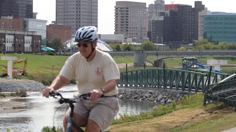 A bicyclist travels along a bike path near Deed's Point MetroPark near downtown Dayton last year. CORNELIUS FROLIK / STAFF