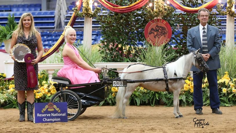 Centerville graduate Olivia Shooter is shown with Sandra, her miniature horse who stays in an MTC barn in Miamisburg. They are shown with the show princess and an event representative. CONTRIBUTED