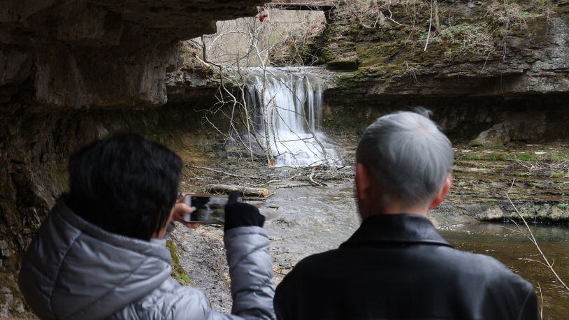 A couple admire one of the waterfalls at Glenn Helen. BILL LACKEY/STAFF