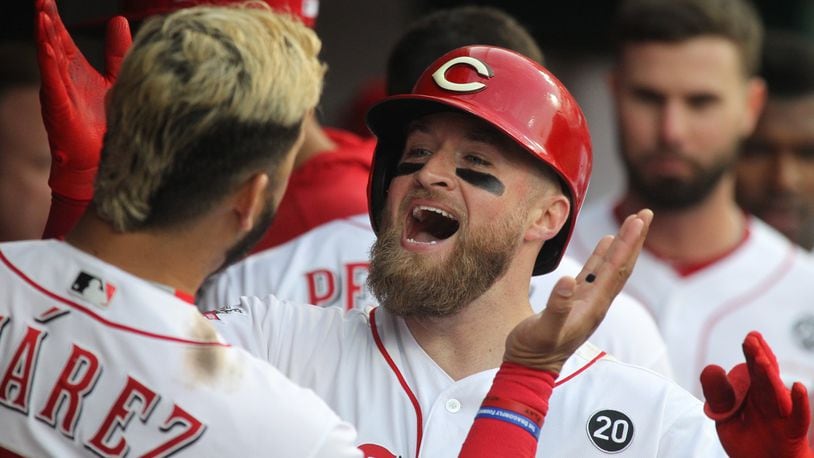 The Reds’ Tucker Barnhart celebrates with Eugenio Suarez after hitting a home run in the fourth inning against the Braves on Tuesday, April 23, 2019, at Great American Ball Park in Cincinnati. David Jablonski/Staff