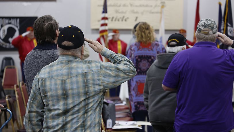 Local veterans salute as the colors are presented during the Vietnam Veterans Day of Remembrance ceremony Saturday, March 25, 2023 at VFW Post 1031 in Springfield. BILL LACKEY/STAFF