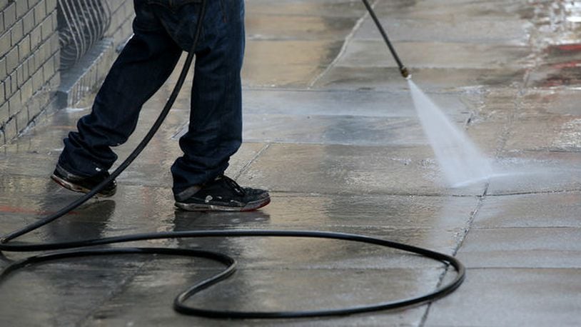 A worker uses a pressure washer to clean the sidewalk in front of a building on May 6, 2015 in San Francisco, California.