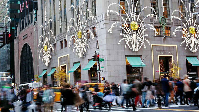 NEW YORK - NOVEMBER 27: Shoppers walk by holiday decor hanging on Tiffany & Co. in New York City on Black Friday, November 27, 2015. Although Black Friday sales are expected to be strong, many shoppers are opting to buy online or retailers are offering year round sales and other incentives that are expected to ease crowds. (Photo by Yana Paskova/Getty Images)
