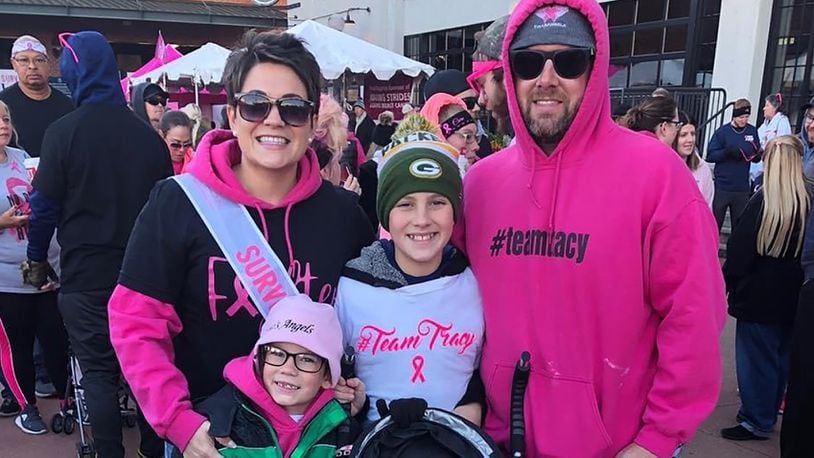 Tracy Evans (L rear) was diagnosed with breast cancer in 2018 when she was just 35 years old. The Evans family, (rear center) son Dominic, husband Curtis (rear R), and younger sons, Preston and Beckham are shown at the Making Strides for Breast Cancer Walk in 2019.