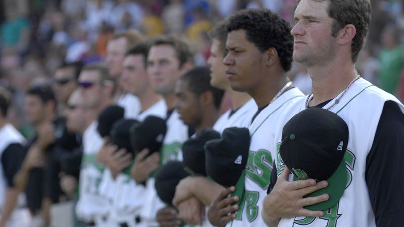 The Dayton Dragons line up for the singing of the national anthem before a game against the Kane County Cougars. Staff photo by Dave Munch