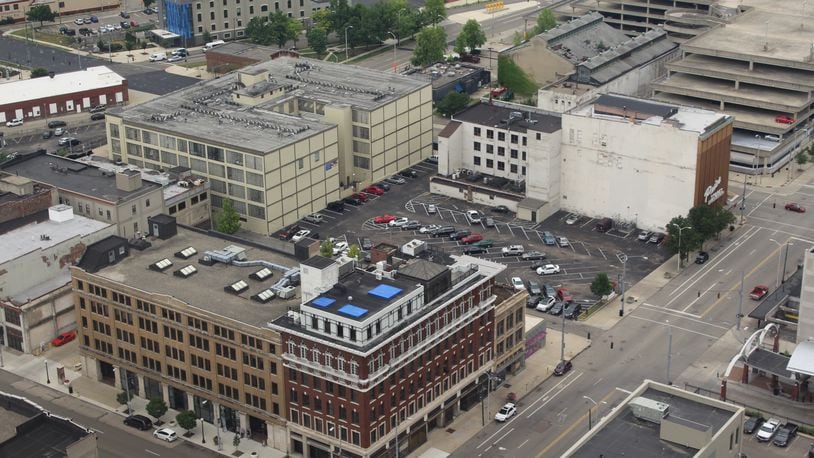 An aerial view of the corner of East Third and Jefferson streets. The Windsor Companies said it owns and controls the red building at the corner (the Elks building, 100 E. Third St.) and the tan building next door (124 E. Third St.). The developer says it has acquired the Price Stores building (52 S. Jefferson St.) and two other properties on East Third and Jefferson streets. CORNELIUS FROLIK / STAFF