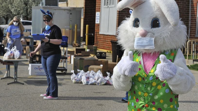 The Fairborn City School District is feeding children every week at food distribution sites throughout the community. Wednesday at the Fairborn Primary School, the Easter Bunny was in attendance with staff to spread a message of hope and inspiration for the days ahead. MARSHALL GORBY/STAFF.