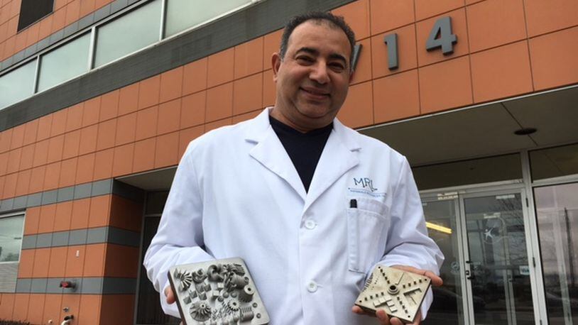 Ayman Salem, founder of Materials Resources LLC, holds examples of metals carefully crafted with 3-D printing processes in his lab. His patents can help clients better understand the “micro-structures” of metals. THOMAS GNAU/STAFF