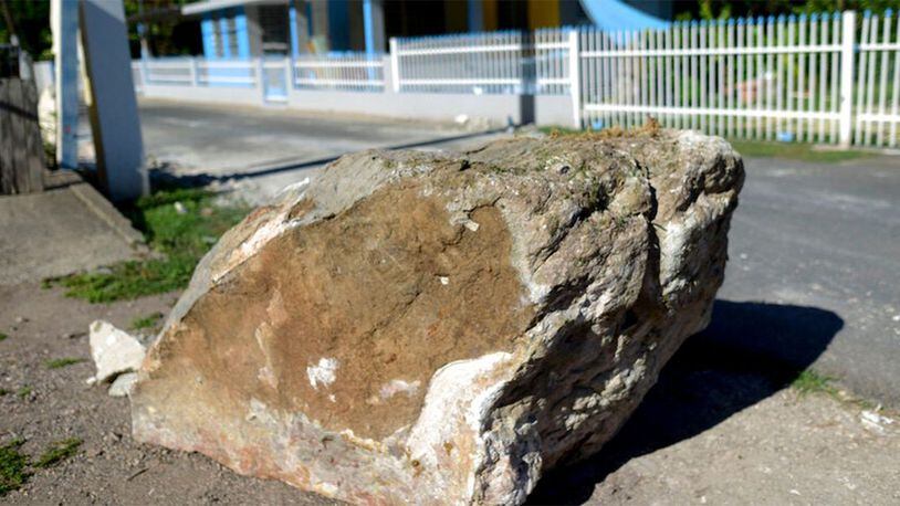 FILE PHOTO: A rock the rolled down a nearby cliff sits on the side of the road after a magnitude 5.9 earthquake in Guanica, Puerto Rico, Saturday, Jan. 11, 2020. Another 5.0 magnitude quake hit the island Tuesday.