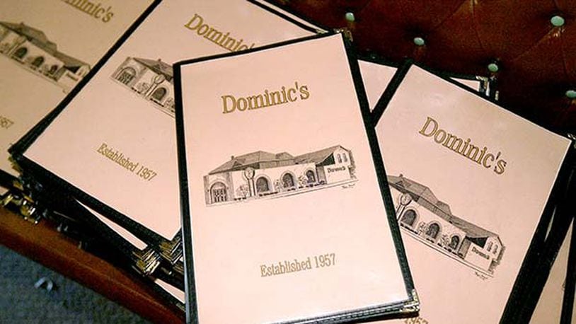 Dozens of menus were stacked up to be sold during an auction at Dominic's, the landmark restaurant at 1066 S. Main St. in Dayton. FILE