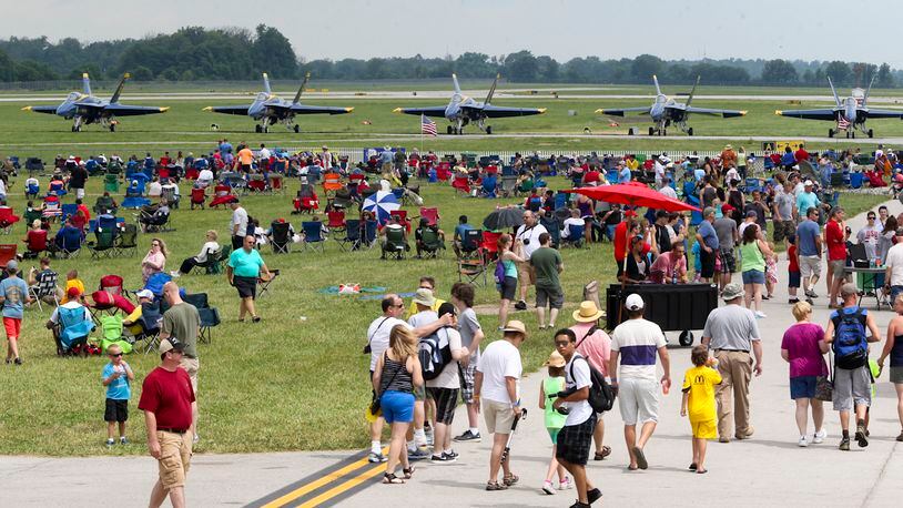 Spectators look over various aircraft including the U.S. Navy Blue Angels during the Vectren Dayton Air Show held at the Dayton International Airport, Sunday, June 29, 2014. GREG LYNCH / STAFF