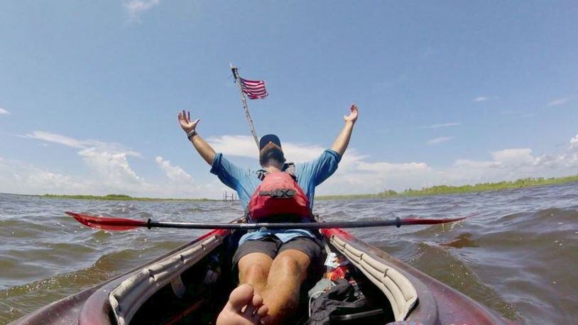 Andy Gallatin savors his arrival in August in the Gulf of Mexico, south of New Orleans, during his 3,000-mile kayak trip. COURTESY OF ANDY GALLATIN