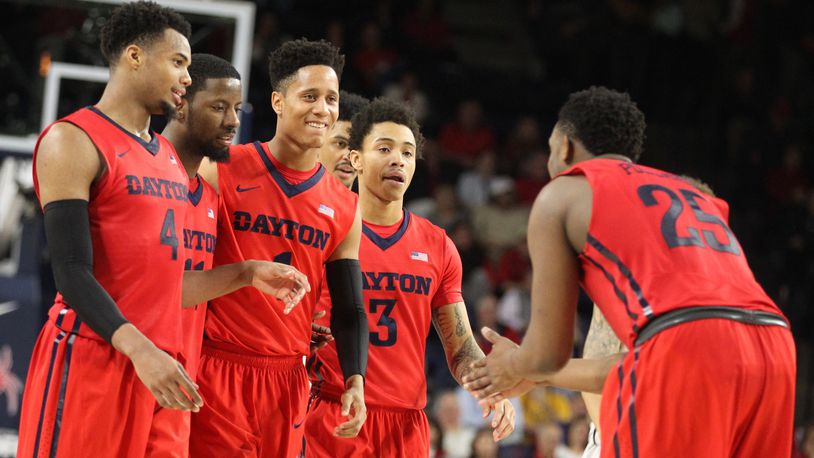 Dayton’s Kendall Pollard, right, greets teammates (left to right) Charles Cooke, Scoochie Smith, Darrell Davis and Kyle Davis in the final minute of a victory against Richmond on Tuesday, March 1, 2016, at the Robins Center in Richmond, Va. David Jablonski/Staff
