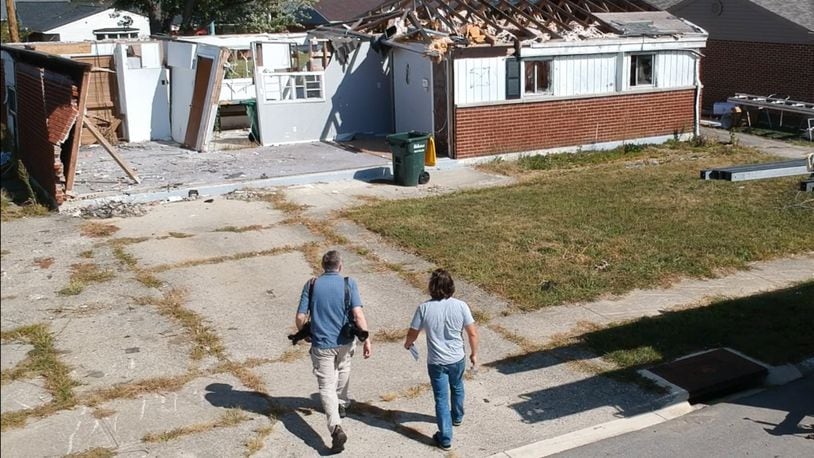 Dayton Daily News reporters Chris Stewart, left, and Josh Sweigart are retracing the path of a devastating EF4 Memorial Day tornado that cut across Montgomery County. They are seen at a house in Brookville's Terrace Park neighborhood. CHUCK HAMLIN / STAFF