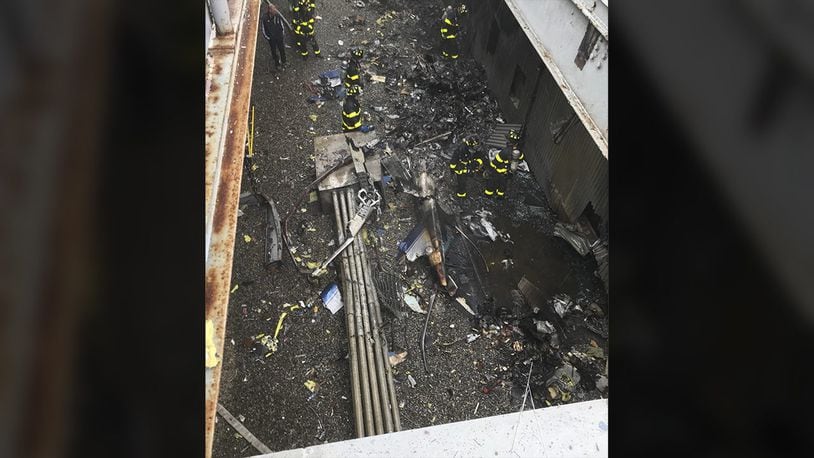 This June 10, 2019 file photo released by the New York City Fire Department shows damage caused by a helicopter crash on the roof of the AXA Equitable building.