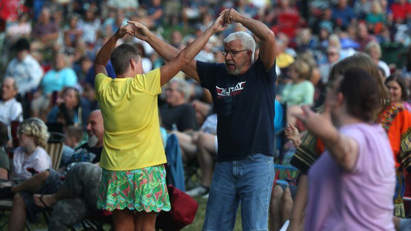 Bud and Yvonne Bell showed the crowd some dance moves as they danced to the music of the K-Tel All-Stars during the opening night of the abbreviated 2021 Summer Arts Festival at Veteran's Park. BILL LACKEY/STAFF