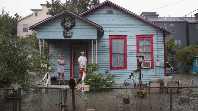 HOUSTON, TX - AUGUST 27:  People on a porch watch as rain from Hurricane Harvey inundates the Cottage Grove neighborhood on August 27, 2017 in Houston, Texas. Harvey, which made landfall north of Corpus Christi late Friday evening, is expected to dump upwards to 40 inches of rain in Texas over the next couple of days.  (Photo by Scott Olson/Getty Images)
