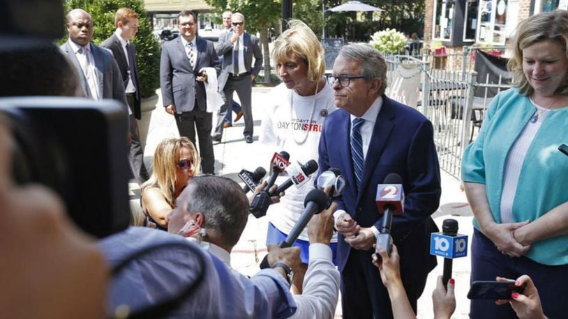 A security detail, top left, followed Gov. Mike Dewine and Dayton Mayor Nan Whaley during a sidewalk press conference in the Oregon District on Aug. 8. Ty Greenlee/WHIO.com