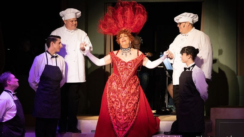Tina McPhearson (appearing with ensemble members as waiters of the Harmonia Gardens restaurant) stars as Dolly Levi in the Dayton Playhouse's production of "Hello, Dolly!" PHOTO BY RICK FLYNN PHOTOGRAPHY