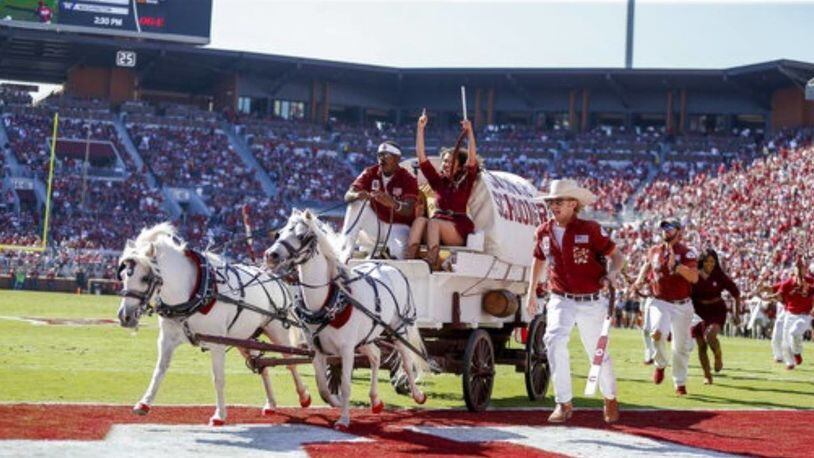 The Sooner Schooner makes a run following a Sooner touchdown in the second quarter against West Virginia on Saturday. The iconic Schooner tipped over after a TD, but no one was hurt.