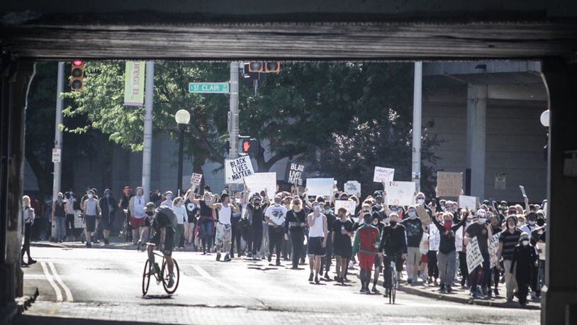 Protesters march on East Fifth Street in Dayton during a demonstration over the weekend.