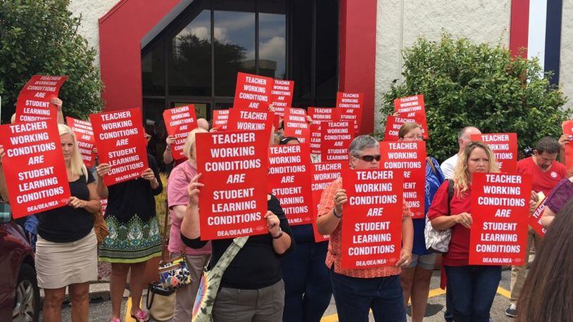 Dayton Education Association members Tuesday protested the lack of a new contract with Dayton Public Schools. Teachers have authorized a strike if a deal is not reached by Aug. 11. JEREMY P. KELLEY / STAFF