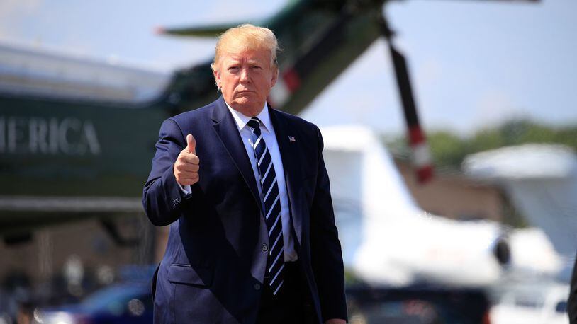 President Donald Trump gives a thumbs-up as he walks on the tarmac to board Air Force One at Morristown Municipal Airport, in Morristown, N.J., on his way returning back to the White House Sunday, July 21, 2019.