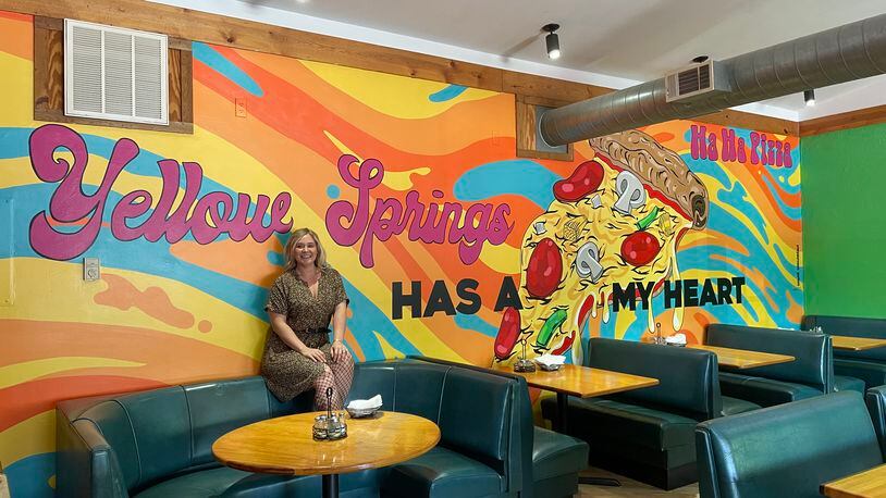 Dayton-area artist Chloé Chicarelli has put her love for Yellow Springs and Ha Ha Pizza on display through a new mural inside the pizza shop. NATALIE JONES/STAFF
