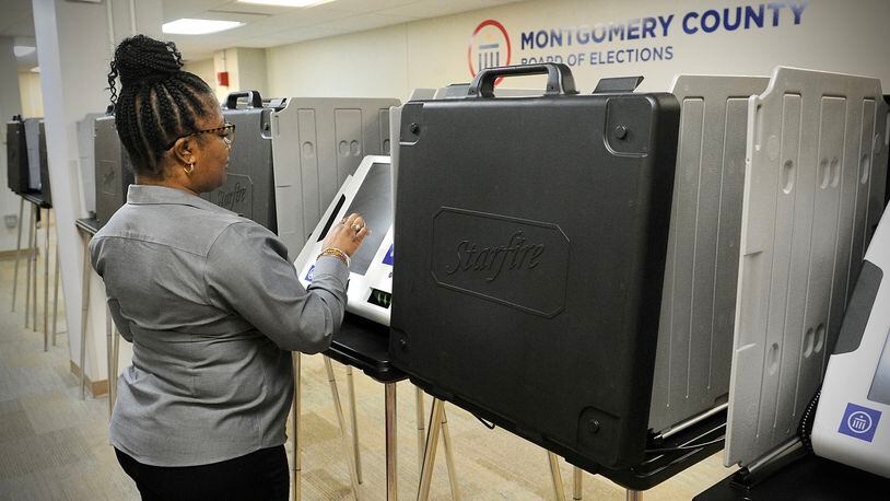 Inger Marsh looks over one of the polling machines at the Montgomery County Board of Elections Wednesday March 24, 2022. MARSHALL GORBY\STAFF