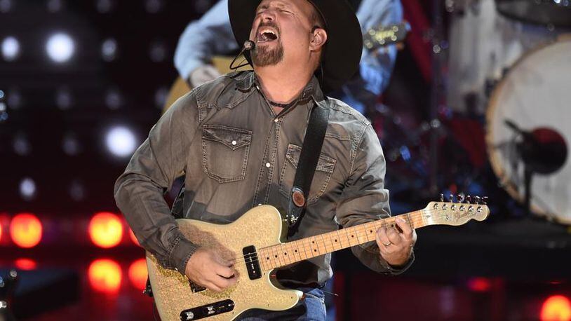 FILE - This March 14, 2019 file photo shows Garth Brooks performing at the iHeartRadio Music Awards in Los Angeles. Brooks is holding a concert in Nashville,Tenn., that will be played at 300 drive-in theaters across the country. Tickets will cost $100 per passenger car or truck.