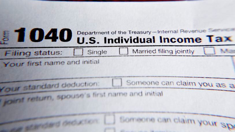 FILE - This Wednesday, Feb. 13, 2019 file photo shows part of a 1040 federal tax form printed from the Internal Revenue Service website, in Zelienople, Pa.  Tax filing season will start a bit later and look a bit different this year. That’s because the pandemic that defined 2020 has seeped into tax time as well. If you worked from home, received a relief payment, took on some gig work or filed unemployment benefits _ or someone filed a fake claim in your name _ there are things you need to be aware of. Likewise if you normally receive certain tax credits. The IRS will begin accepting tax returns on Feb. 12, 2021.  (AP Photo/Keith Srakocic, File)