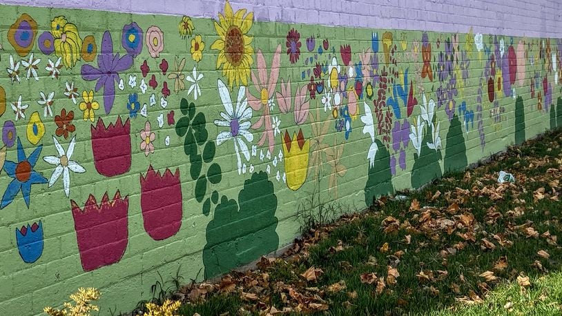 Forest Wortham of Washington Twp. took this photo on Nov. 19 of a mural on the side of a building at 425 Xenia Ave., Dayton. He says, “A hidden mural of bright, lively spring and summer flowers contrasts with dead leaves in the grass.”