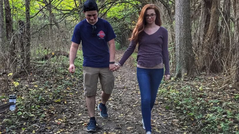 Ryan Williams of Lancaster and Savannah Martin of Bexley enjoy walking through the Osage Orange Tunnel at Sugarcreek MetroPark for the first time.
