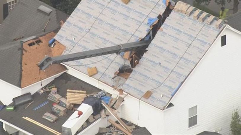 A crane smashed into a home that was undergoing roof repairs in Orlando.