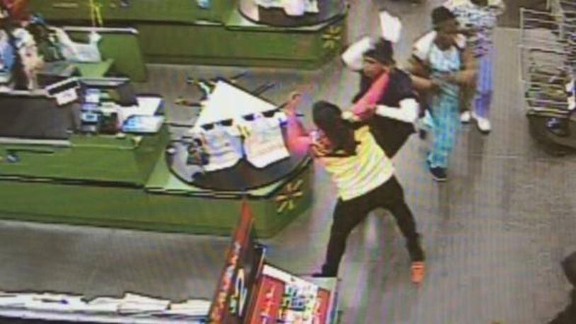 Four people wearing scrubs were caught on camera robbing a Georgia Walmart. (Photo: Gwinnett County police)