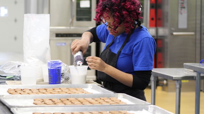 In early 2017, AmeriCorps member Shantel Hart worked at Lindy & Company at 701 S. Patterson Blvd. The business sells 10 different types of gourmet dog treats, which are made by and support homeless youth. CORNELIUS FROLIK / STAFF