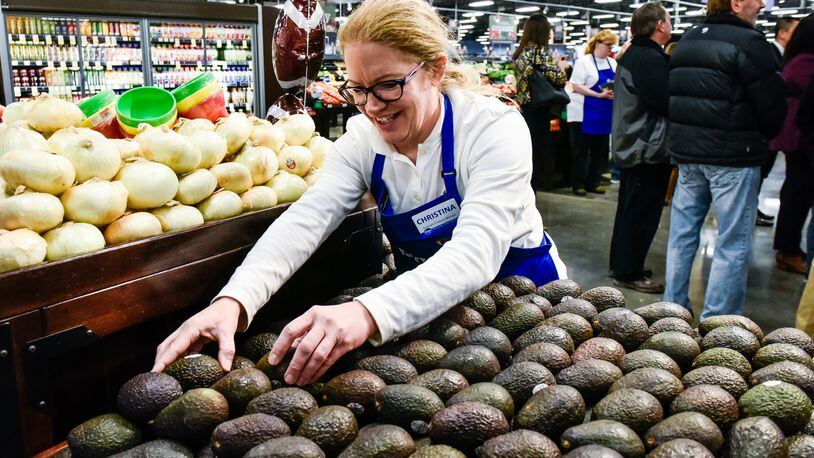 Christina Burkart organizes produce at the new Kroger Marketplace at Crossings of Beckett on Princeton Glendale Road near Tylersville Road in West Chester Township. NICK GRAHAM/STAFF