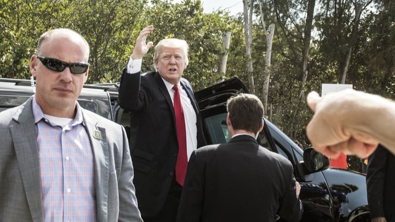 President Donald Trump stops his motorcade to greet supporters on Bingham Island outside Palm Beach on Sunday March 19, 2017, on his way to Palm Beach International Airport.