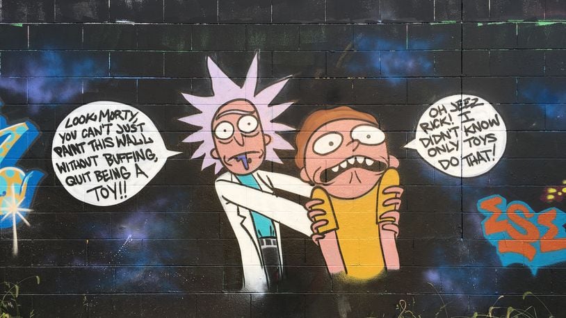 There's a mural of characters from the popular Adult Swim show 'Rick and Morty' on the wall of Stop-N-Lock on 3636 Linden Ave. in Dayton. ALLEGRA CZERWINSKI / STAFF PHOTO