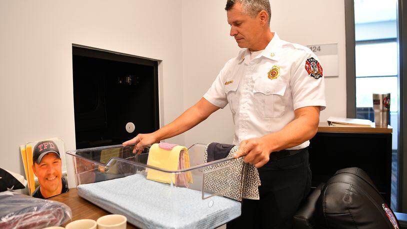 Troy Fire Chief Matthew Simmons works with the new “baby box” included in the construction of the city’s new fire station.
